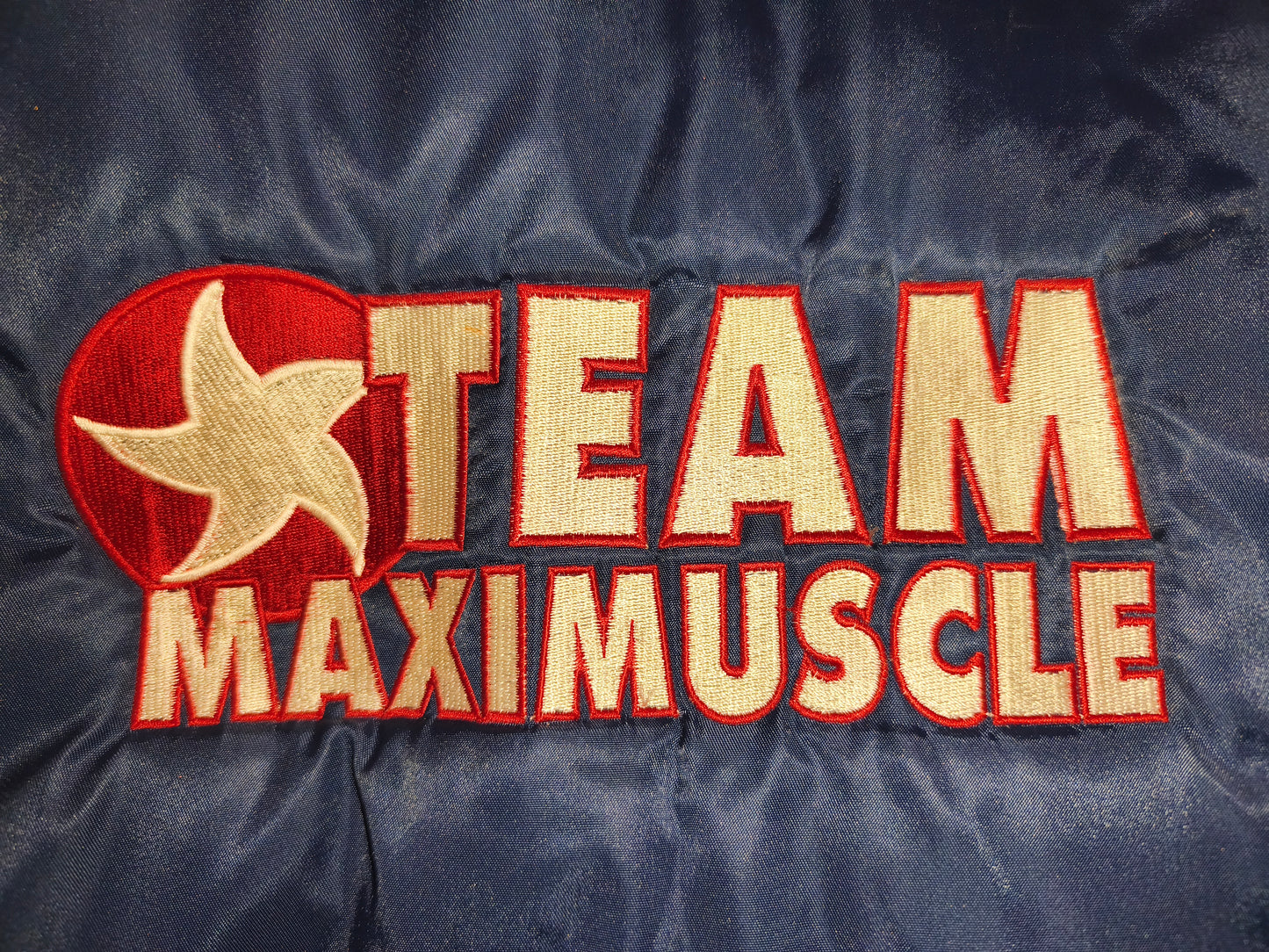 Classic 90s/Y2K bomber jacket featuring bold "Team Maximuscle" chest & back embroidery!